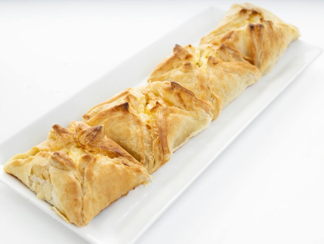 Delicious golden-brown baked pastry, perfect for breakfast or snacks, elegantly presented on a white plate.